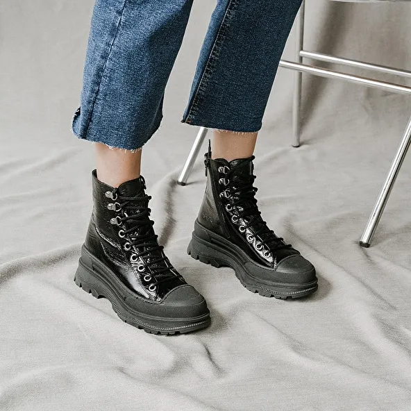 Boots with laces and notched soles in black aged leather